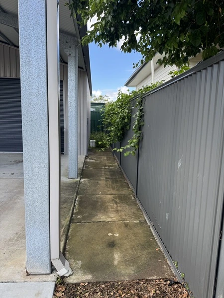 down the side of Redlands Coast property requiring cleaning with slippery concrete